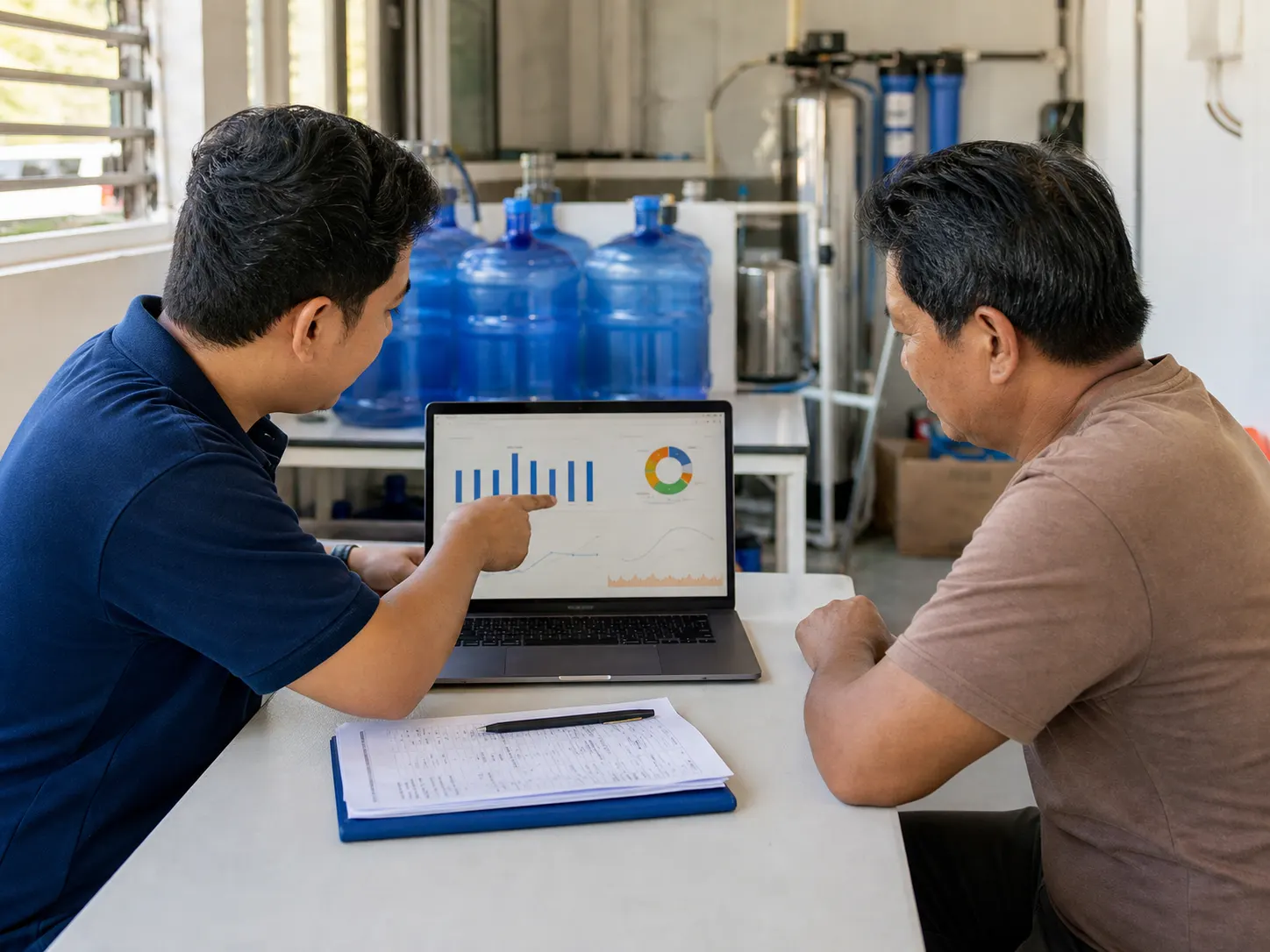 Technician reviewing an energy dashboard with a business owner